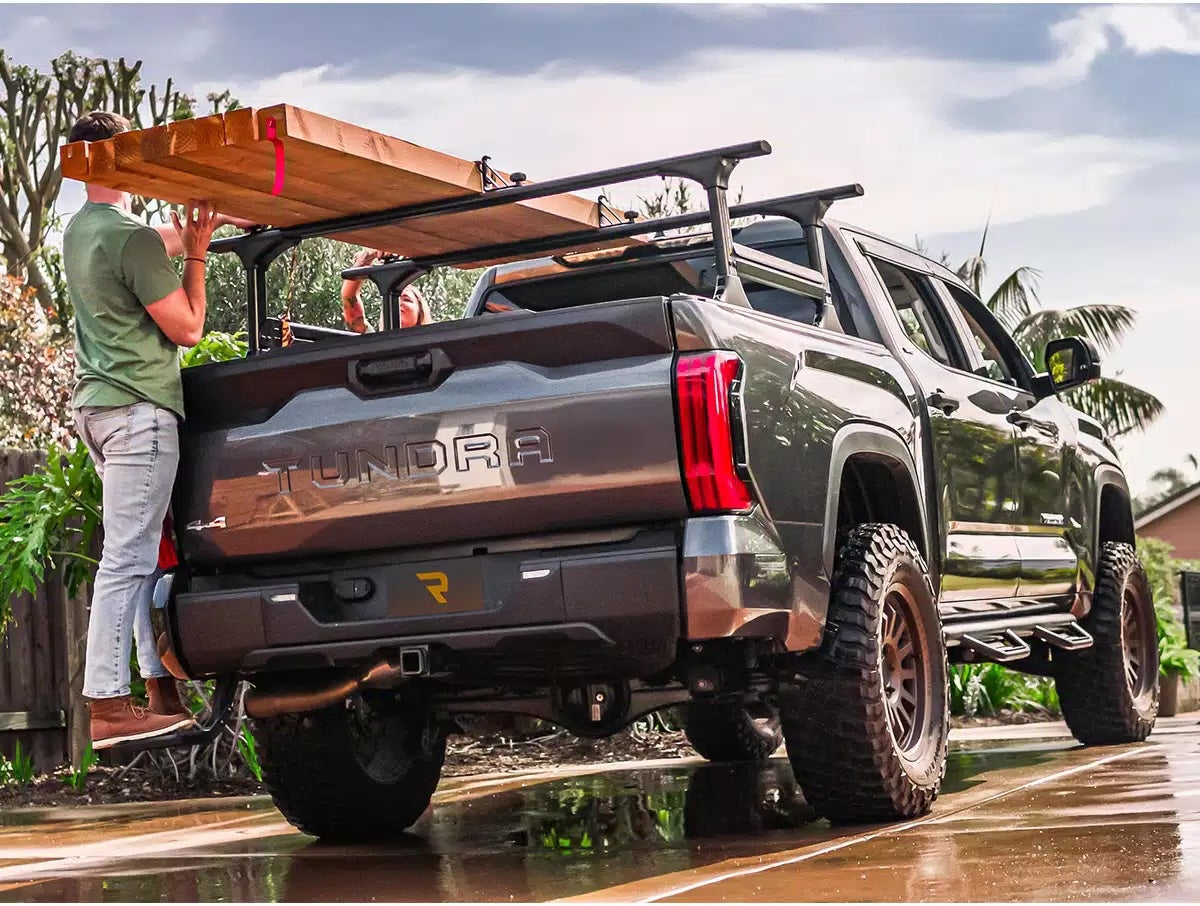 oyota Tundra fitted with an elevated truck rack for carrying timber and oversized cargo.